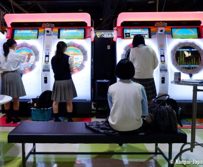 Japanese girls playing at an arcade game (Game Center) in Tokyo