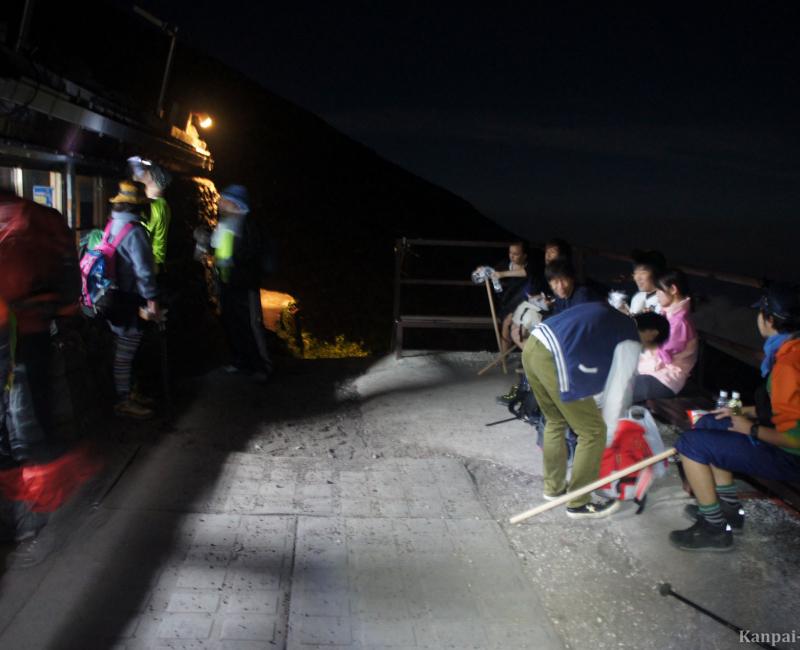 Hikers taking a break at a station on Mount Fuji Hikers taking a break at a station on Mount Fuji