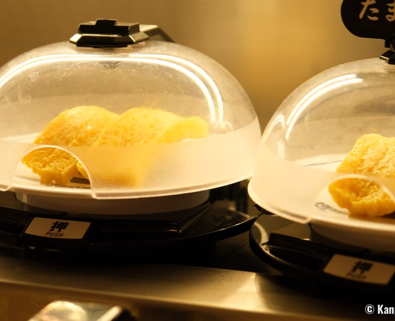 Kura Sushi, Global Flagship Store Oshiage Station (Tokyo SkyTree), Tamagoyaki sushi under antibacterial covers Kura Sushi, Global Flagship Store Oshiage Station (Tokyo SkyTree), Tamagoyaki sushi under antibacterial covers