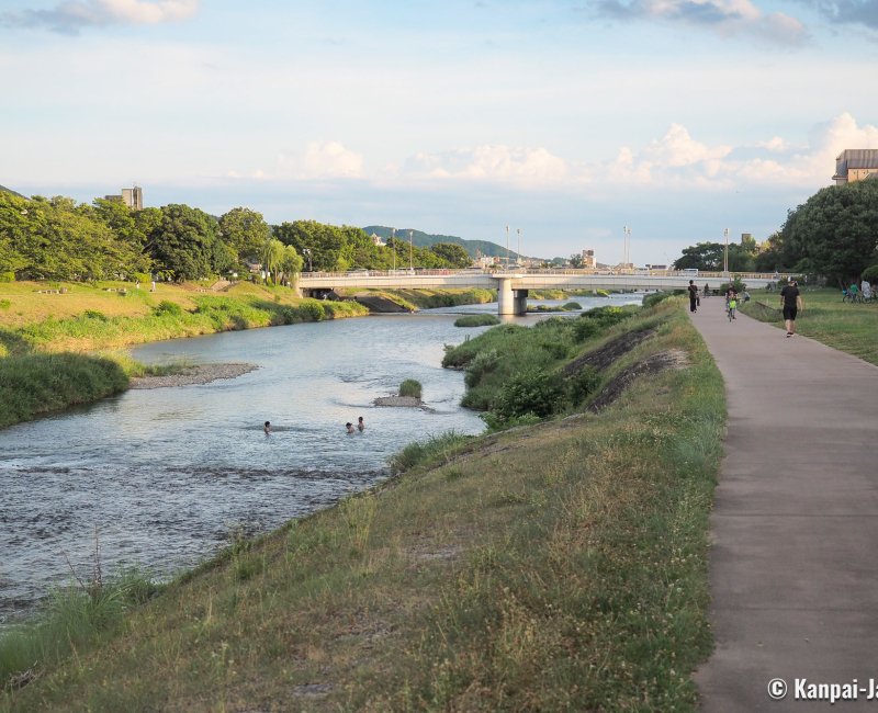 Summer Heat in Japan, People swimming in the Kamo-gawa river in Kyoto Summer Heat in Japan, People swimming in the Kamo-gawa river in Kyoto