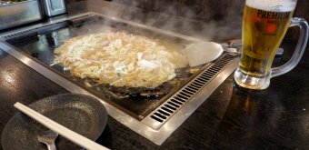 Tsukishima (Tokyo), Monjayaki ingredients cooking on an iron hot plate