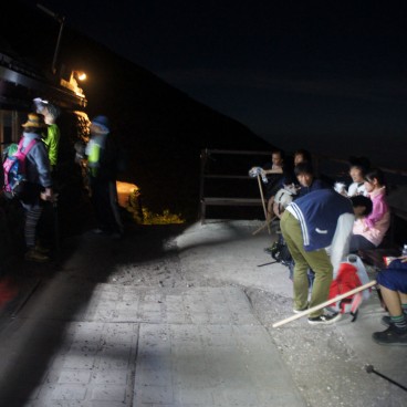 Hikers taking a break at a station on Mount Fuji
