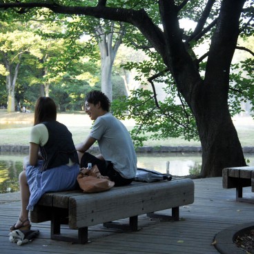 Yoyogi Park in Tokyo, Couple sitting on a bench under the trees