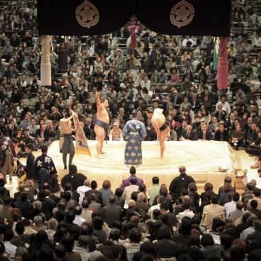 Sumo tournament in Osaka, Wrestlers and referee on the dohyo ring before the bout
