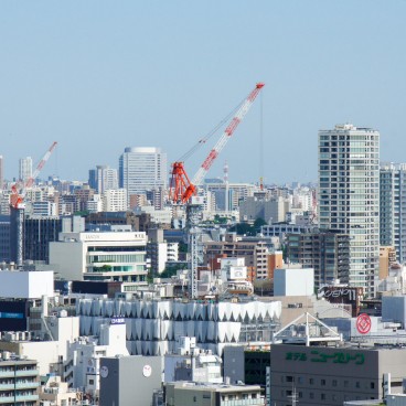 View on the rooftops of Tokyo and construction cranes