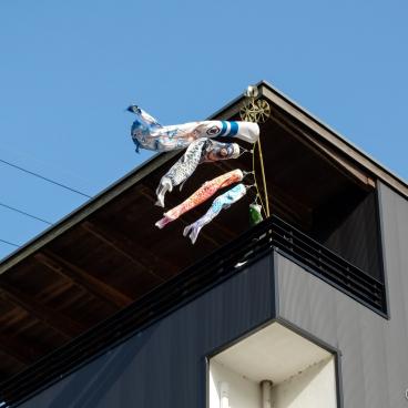 Traditional koi nobori pole hanged on a house's balcony in Japan
