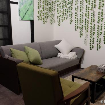 Shiki Asuka House (Kyoto), living-room area with sofa, armchair and television