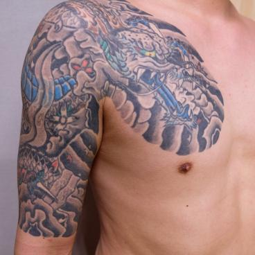 Traditional Japanese tattoo on a man's shoulder and arm