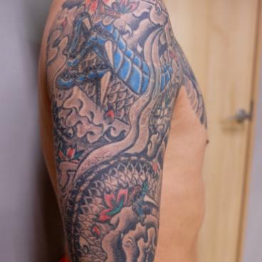 Traditional Japanese tattoo on a man's shoulder and arm 2