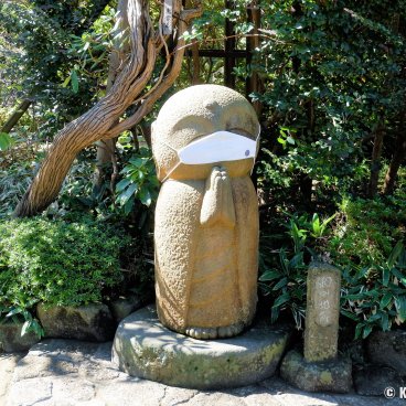 Kamakura, Jizo statue wearing a face mask during the Covid pandemic