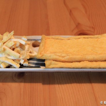 Aburaage fried tofu in slices and pieces in a plate