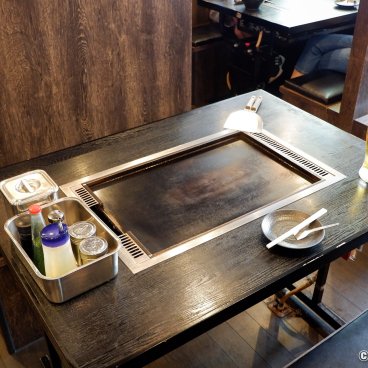 Tsukishima (Tokyo), Table with iron plate for cooking in a monjayaki restaurant