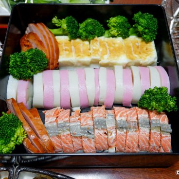 Osechi Ryori, Traditional dishes, including Kamaboko fish cake, in a bento box