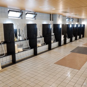 Capsule Inn Osaka (Umeda), Shower area in the sento at the New Japan Umeda spa center